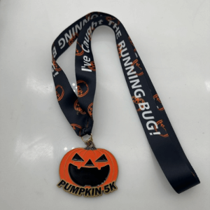 Close-up of the Pumpkin 5K medal featuring a jack-o'-lantern design