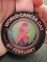 World Cancer Day medal with pink ribbon