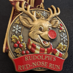 Rudolph medal with red nose and holly