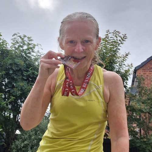 Runner biting medal after race outdoors